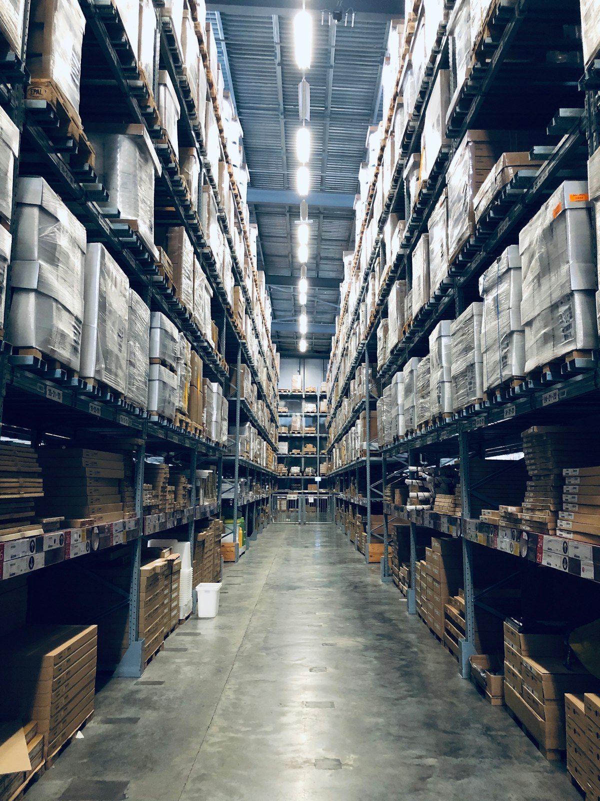 Organised warehouse aisle storing export-ready goods